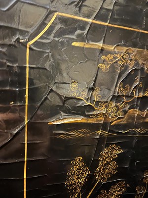 Lot 643 - A black and gilt lacquer folding screen