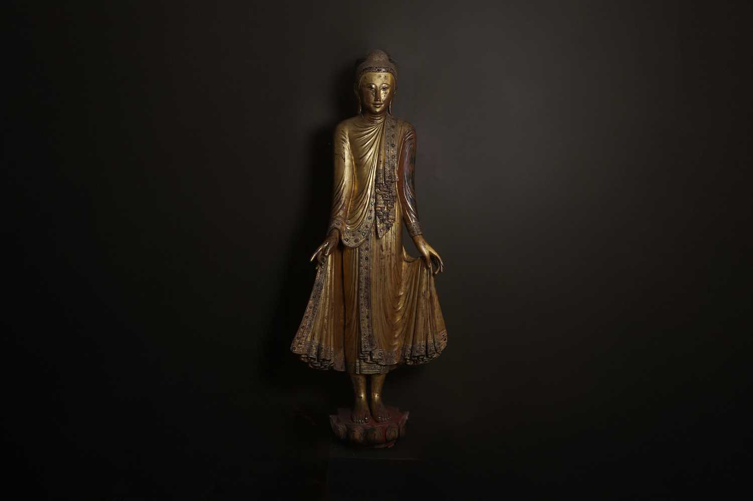 Lot 637 - A very large lacquered and giltwood figure of the standing Buddha