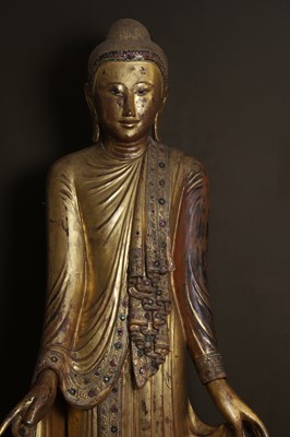 Lot 637 - A very large lacquered and giltwood figure of the standing Buddha