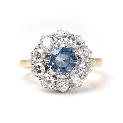 Lot 1152 - A sapphire and diamond cluster ring