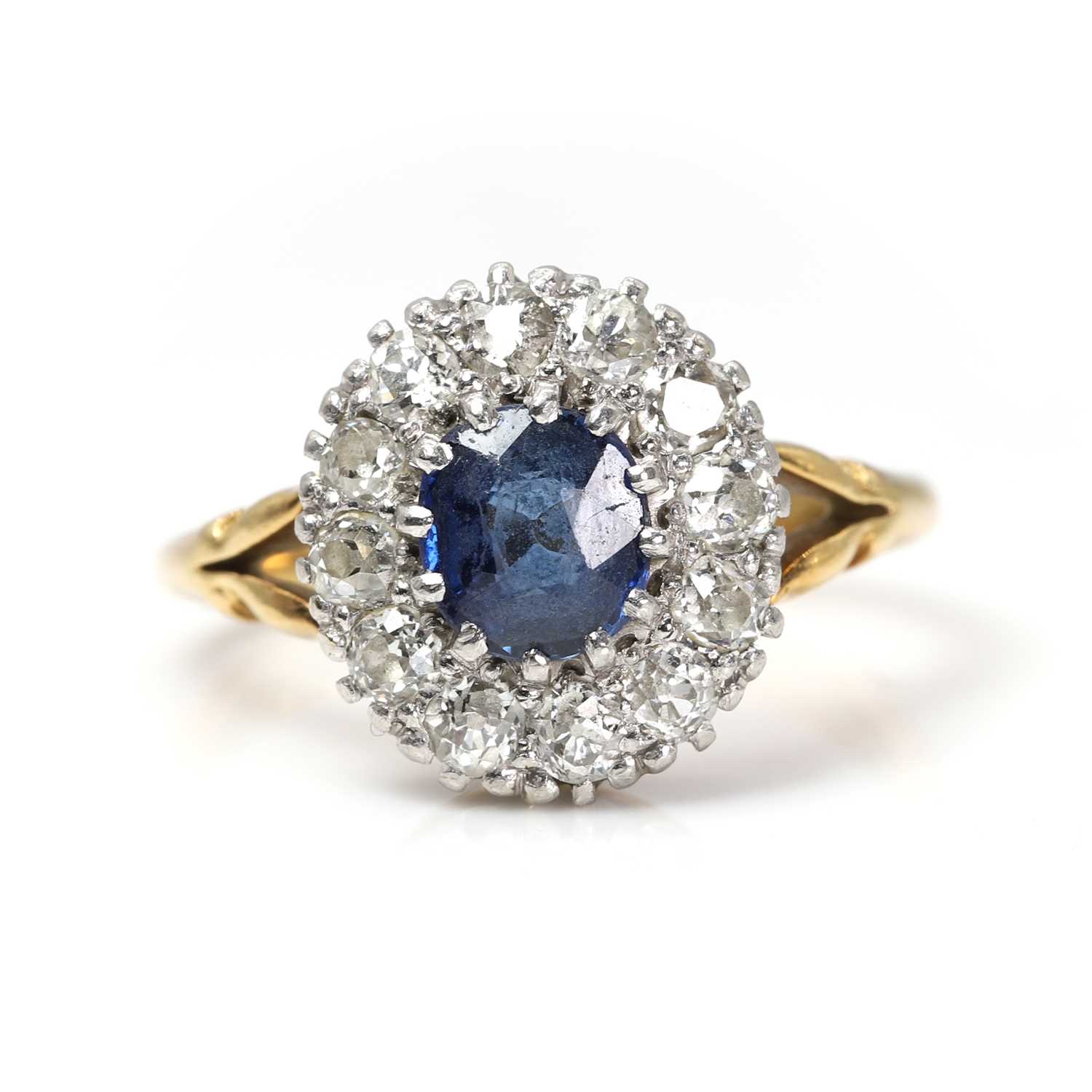 Lot 1060 - A sapphire and diamond cluster ring