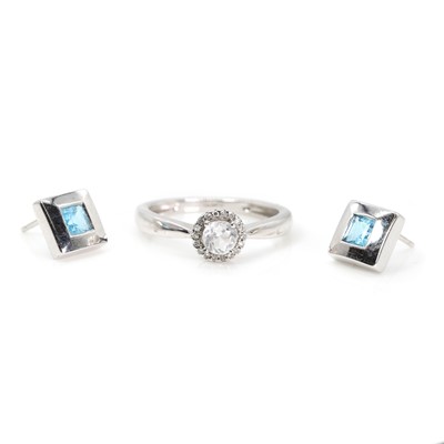 Lot 1320 - A 9ct white gold cubic zironia ring and a pair of white gold topaz stud earrings