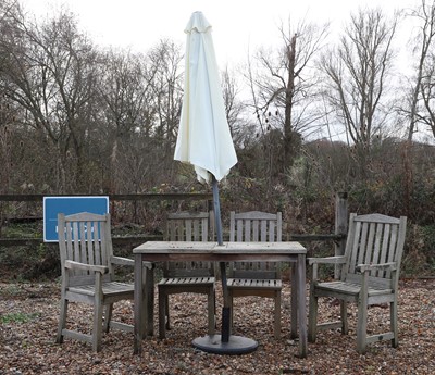 Lot 763 - A teak garden table and four chairs and umbrella