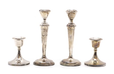 Lot 24 - A pair of silver candlesticks