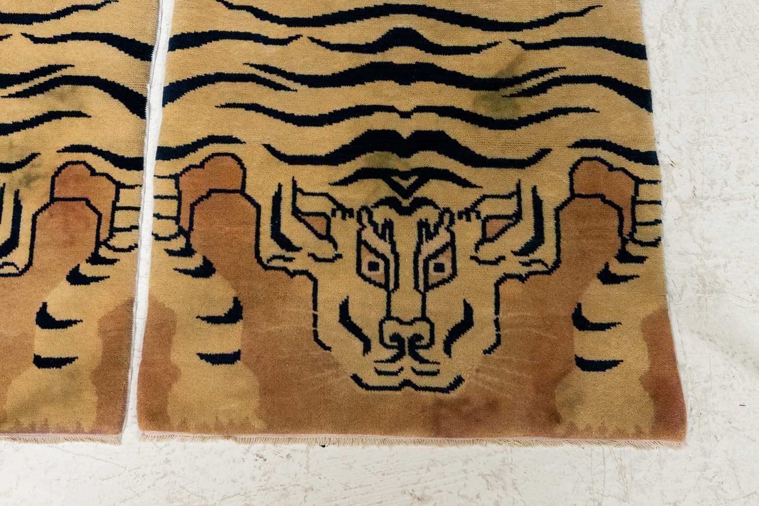 Lot 33 - A pair of wool 'tiger' rugs