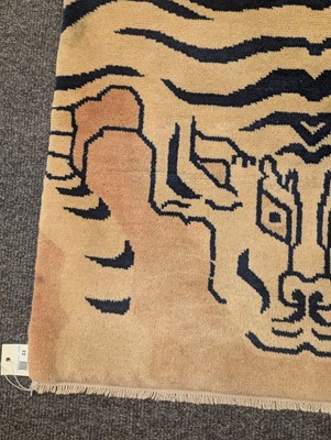 Lot 33 - A pair of wool 'tiger' rugs
