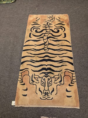 Lot 33 - A pair of wool 'tiger' rugs