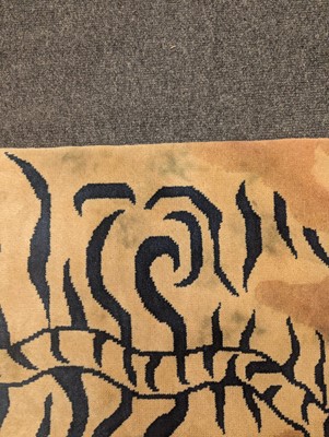 Lot 33 - A pair of wool 'tiger' rugs
