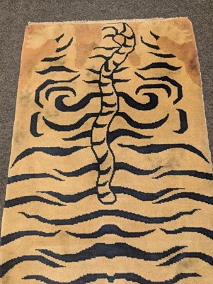 Lot 33 - A pair of wool 'tiger' rugs