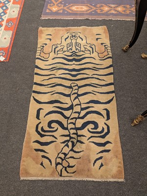 Lot 33 - A pair of wool 'tiger' rugs
