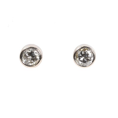 Lot 1106 - A pair of 18ct white gold diamond stud earrings