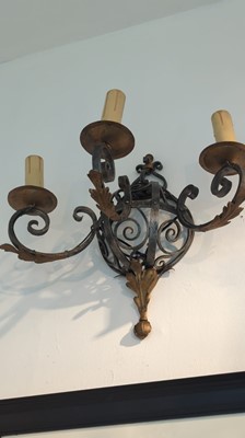 Lot 57 - A set of three wrought-iron wall lights