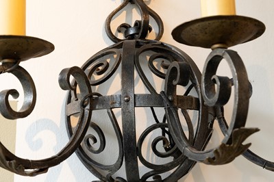 Lot 57 - A set of three wrought-iron wall lights