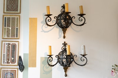 Lot 57 - A set of three wrought-iron wall lights