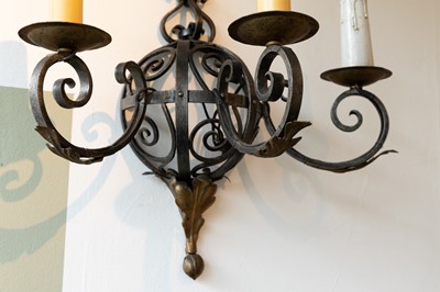 Lot 57 - A set of three wrought-iron wall lights