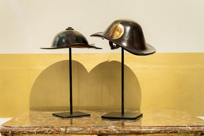 Lot 117 - A near pair of lacquered helmets