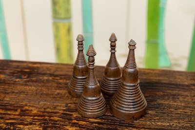 Lot 129 - A set of four miniature wooden stupa