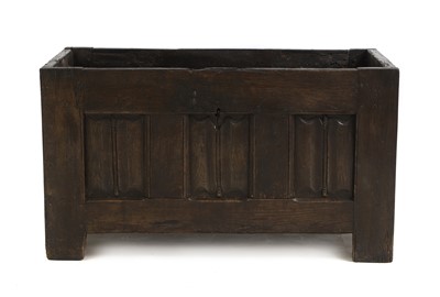 Lot 728 - An oak three panelled linen fold carved log box