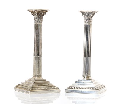 Lot 31 - A pair of silver-plated Corinthian silver candlesticks