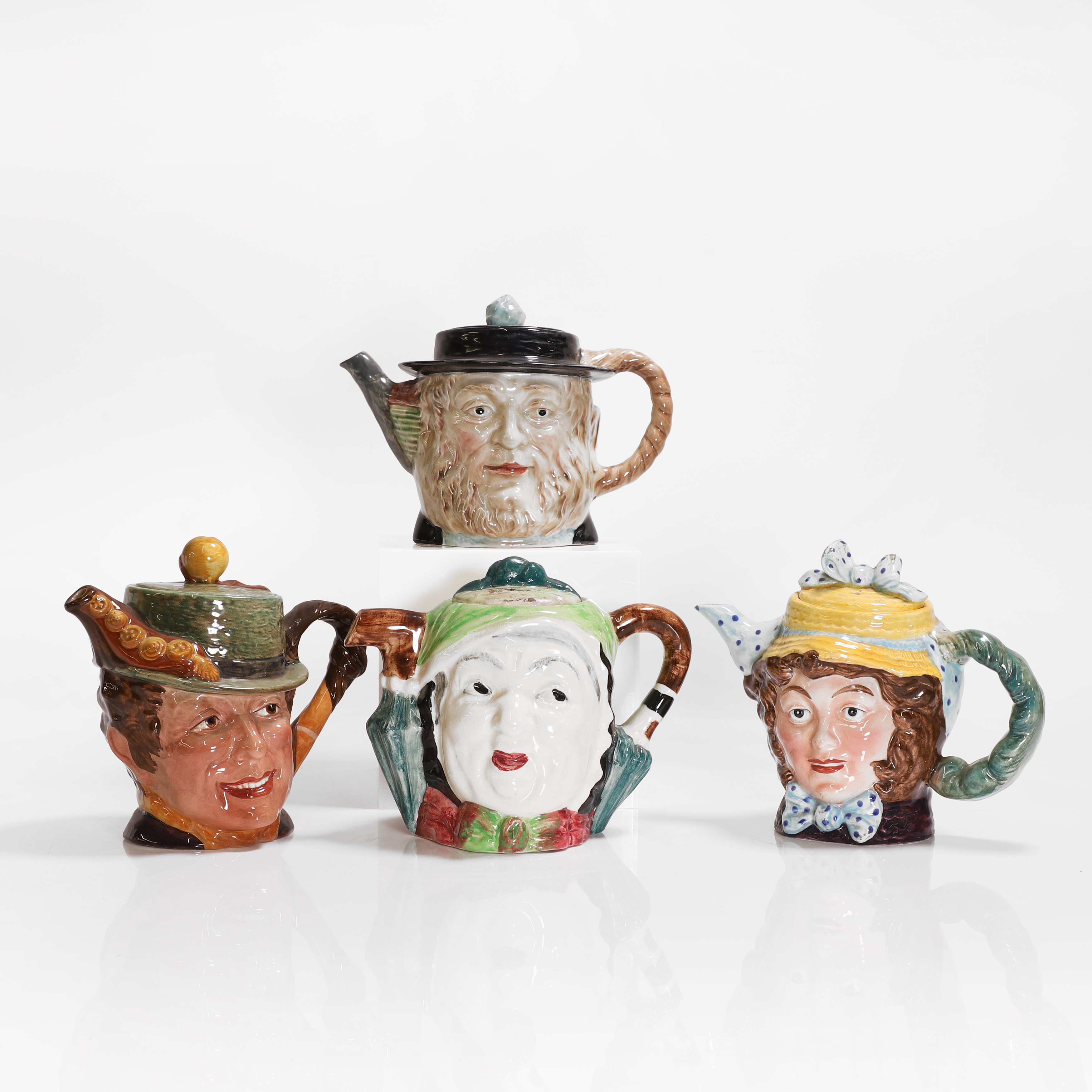 Lot 178 - Four pottery teapots and covers,