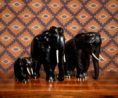 Lot A group of ebonised carved wood elephants