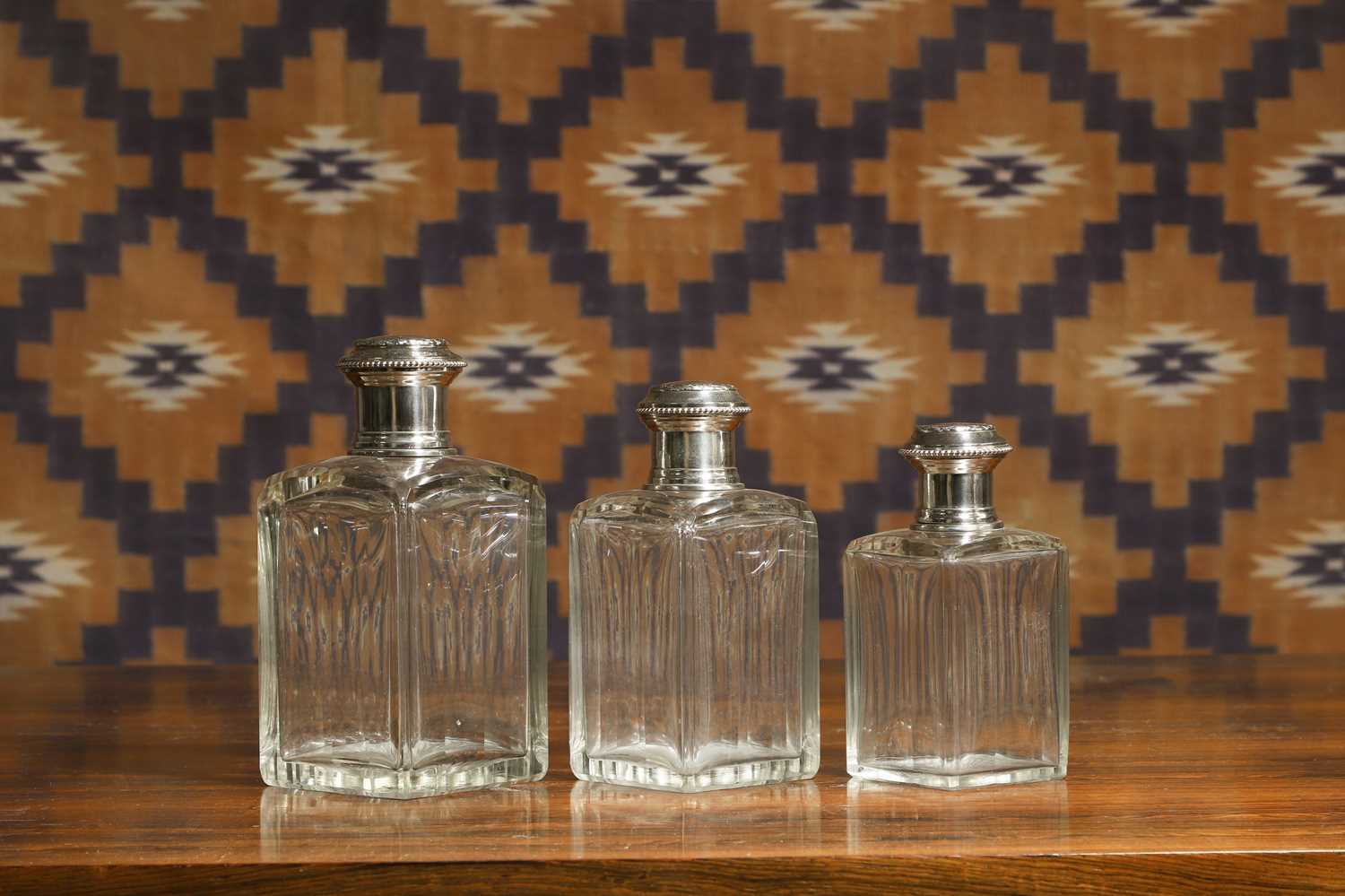 Lot 597 - A set of three French silver mounted glass perfume bottles