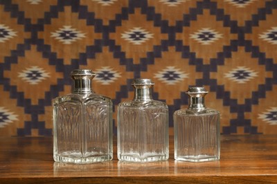 Lot A set of three French silver mounted glass perfume bottles