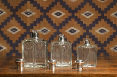 Lot 597 - A set of three French silver mounted glass perfume bottles