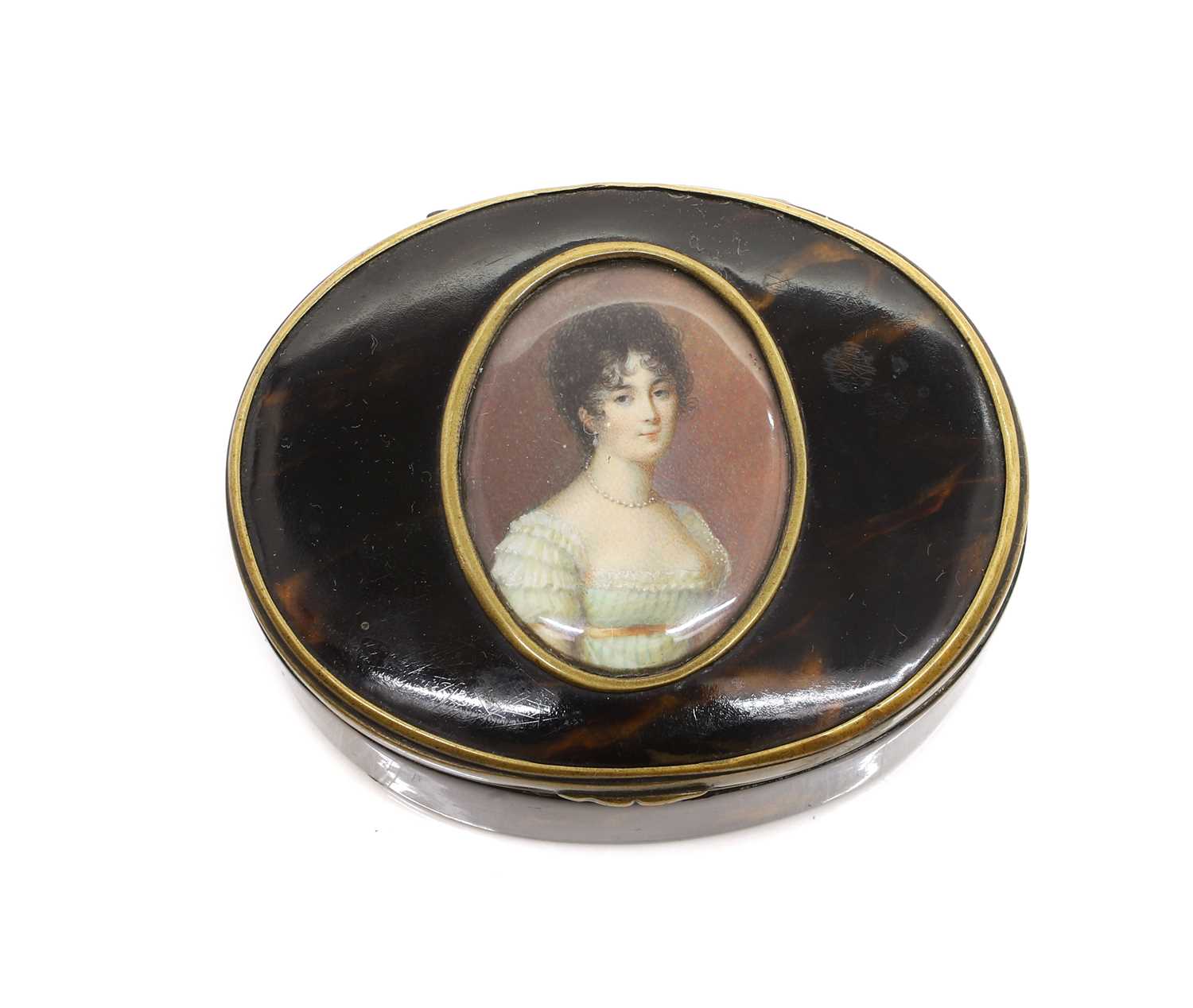 Lot 132 - A tortoiseshell and brass mounted oval snuff box