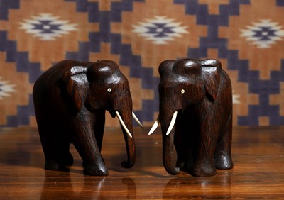 Lot A pair of Indian hardwood elephant figures