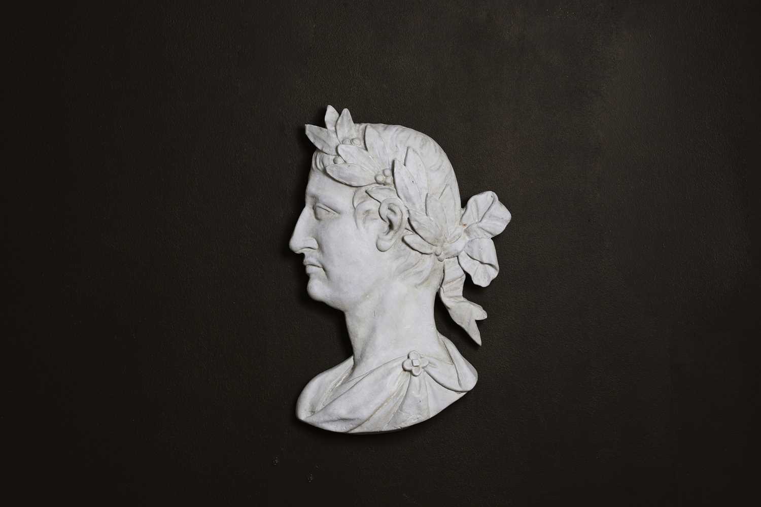 Lot 638 - A painted plaster profile portrait