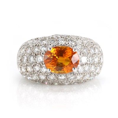 Lot 161 - A platinum orange sapphire and diamond bombé ring