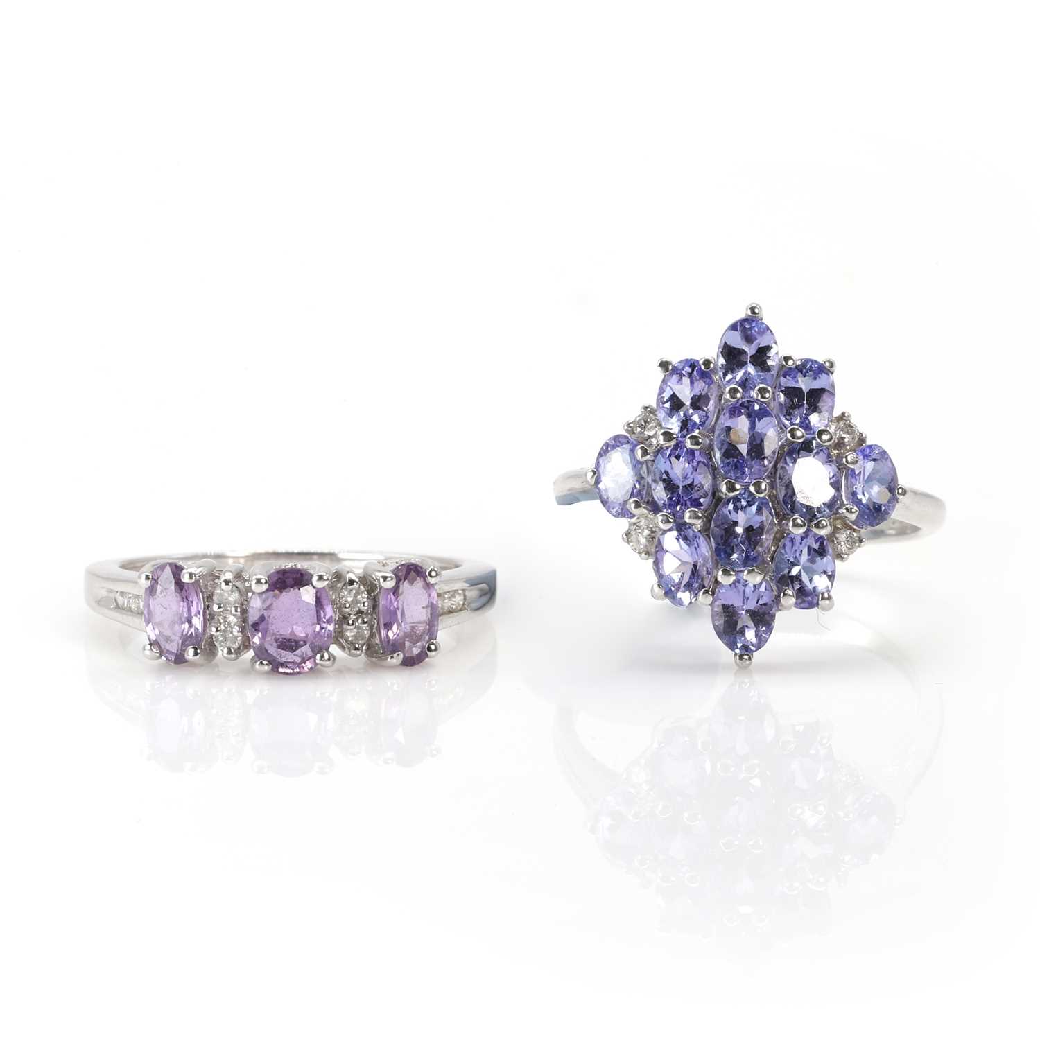 Lot 188 - A 9ct white gold tanzanite cluster ring and a 9ct white gold pink sapphire ring