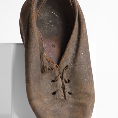 Lot 13 - A petrified child's chimney shoe