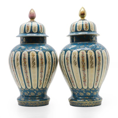 Lot 140 - A pair of Sèvres style porcelain vases and covers