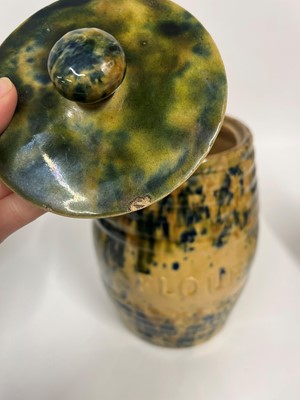 Lot 516 - A set of three glazed earthenware storage jars and covers
