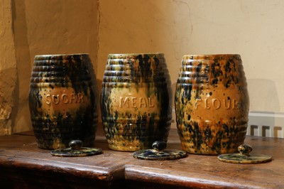Lot 516 - A set of three glazed earthenware storage jars and covers