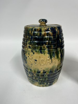Lot 516 - A set of three glazed earthenware storage jars and covers