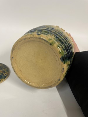 Lot 516 - A set of three glazed earthenware storage jars and covers