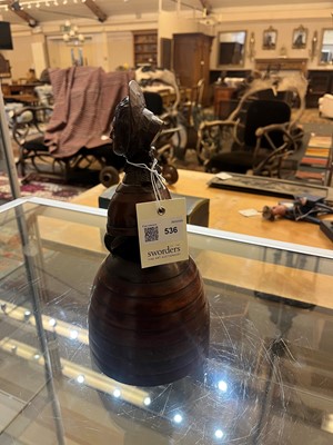 Lot 536 - A treen caricature walnut money bank