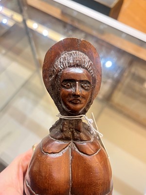Lot 536 - A treen caricature walnut money bank