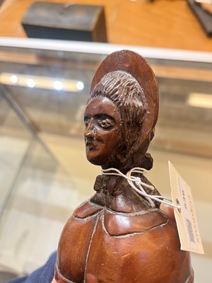 Lot 536 - A treen caricature walnut money bank