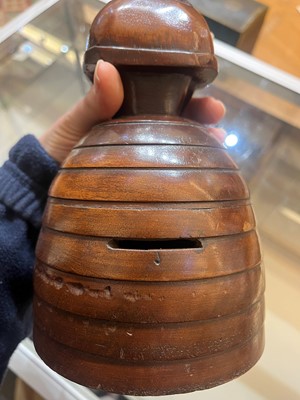 Lot 536 - A treen caricature walnut money bank