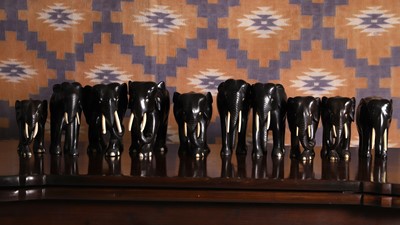 Lot A series of ten ebony elephants of various sizes