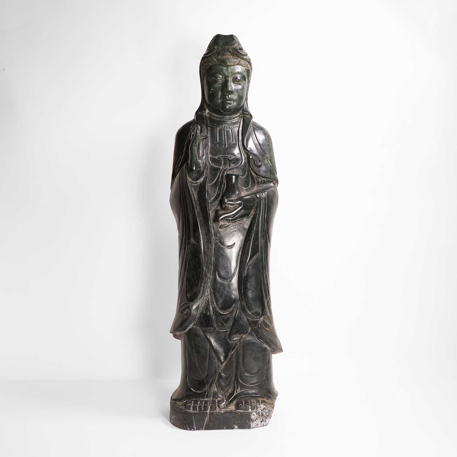 Lot 125 - A large Chinese spinach jade carving