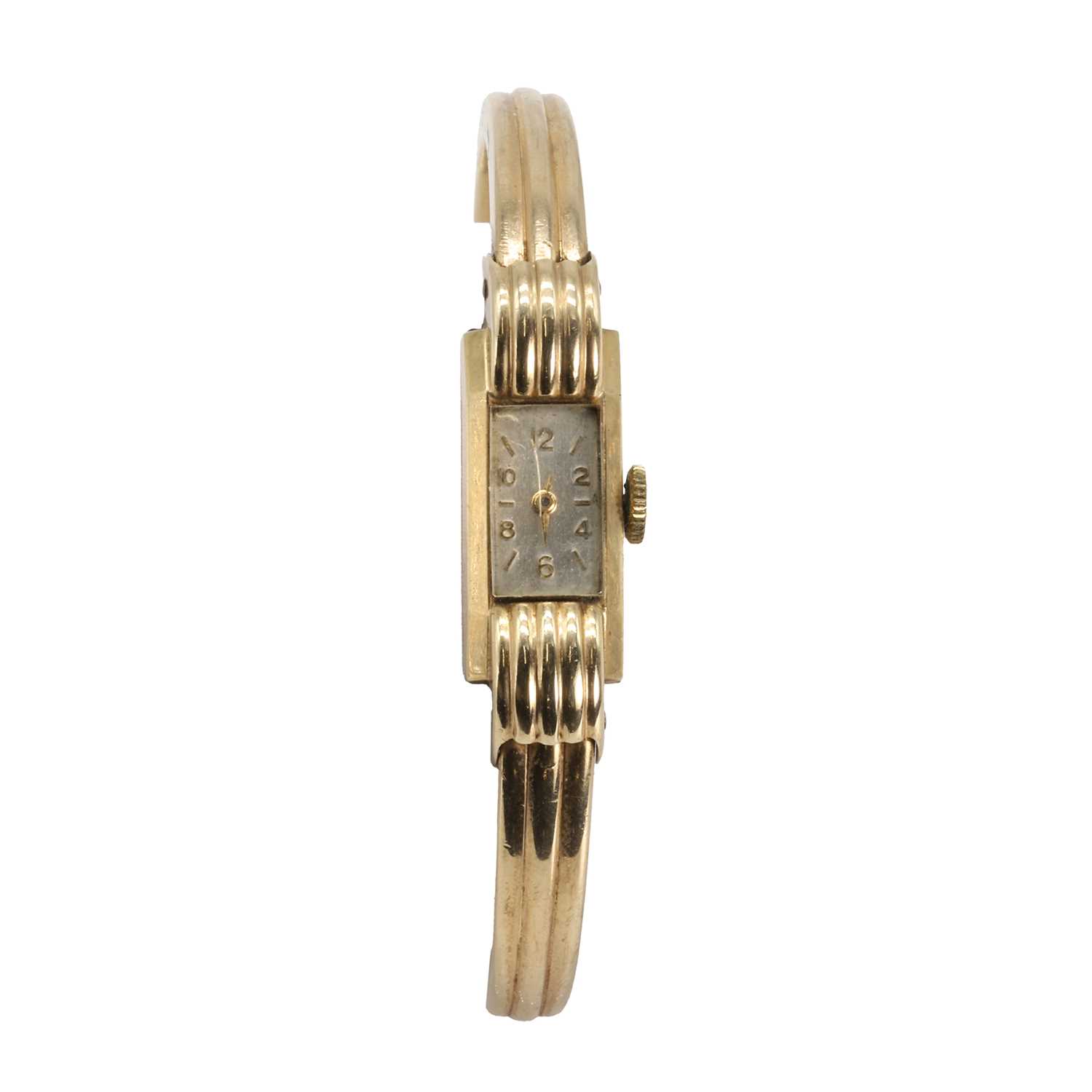 Lot 420 - A 9ct gold ladies' mechanical bangle watch
