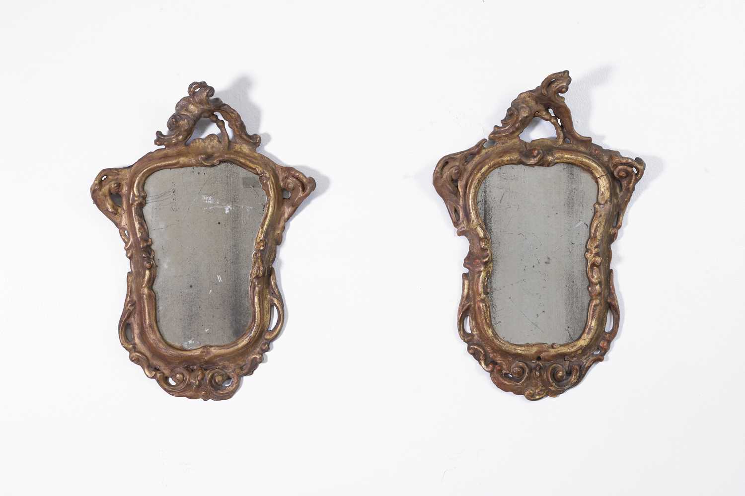 Lot 36 - A pair of small rococo giltwood mirrors