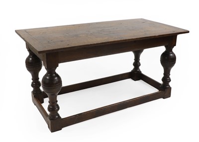 Lot 542 - A large oak drawer leaf refectory table