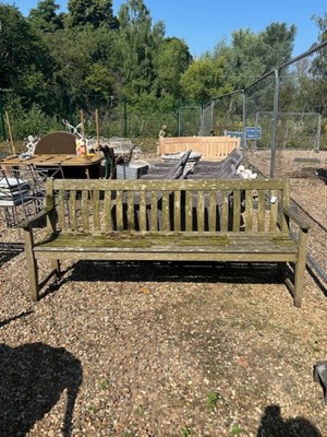 Lot 593 - A large teak slatted garden seat