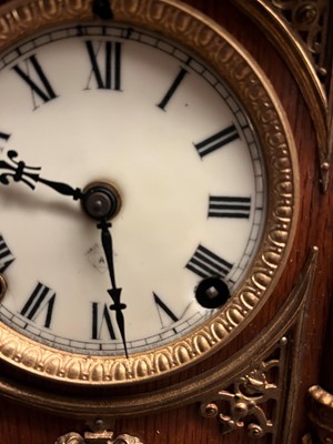 Lot 384 - A oak and gilt-metal mantel clock